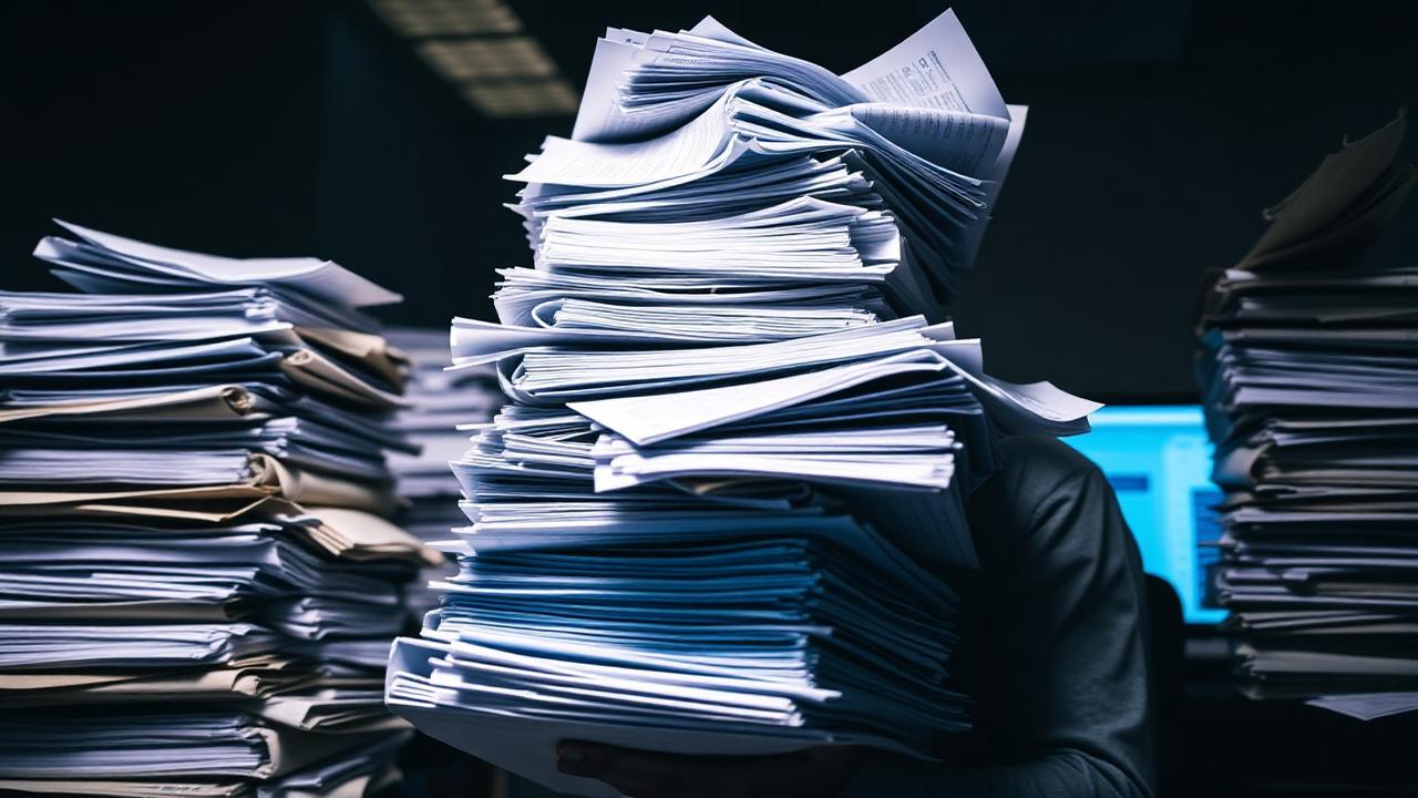 Stacks of paper representing the manual audit process